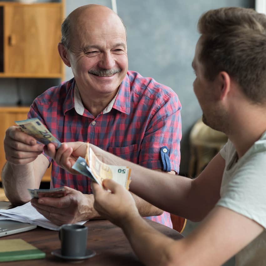 Father giving adult son money