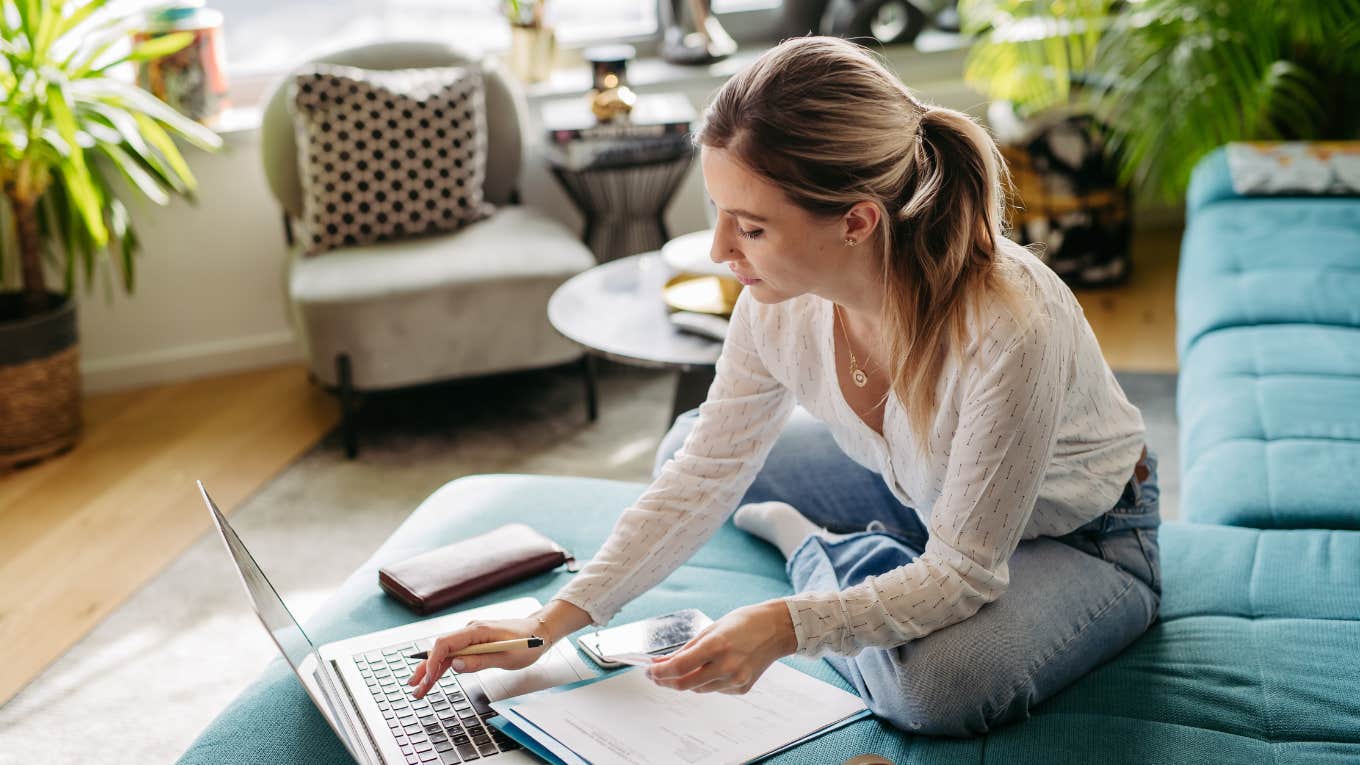 Financially Responsible 23-Year-Old Shares 3 Things That Keep People In Their 20s Broke woman on laptop making a budget