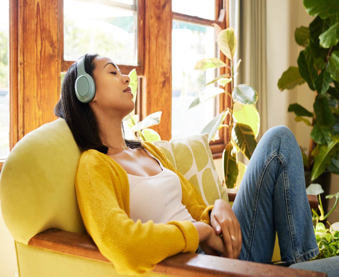 woman listening to music while sitting