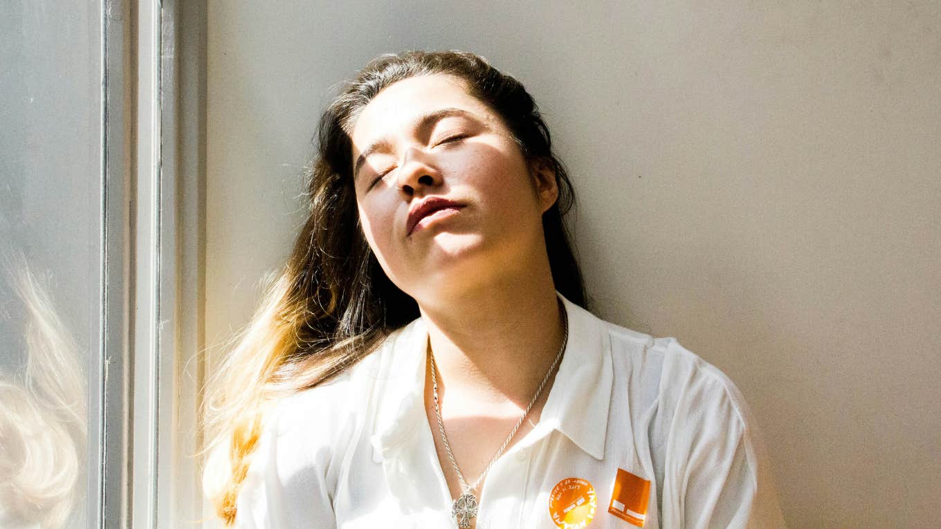 Signs You're An Overfunctioning Empath, According To An Expert On Highly Sensitive Persons woman overwhelmed because she's an overfunctioning empath