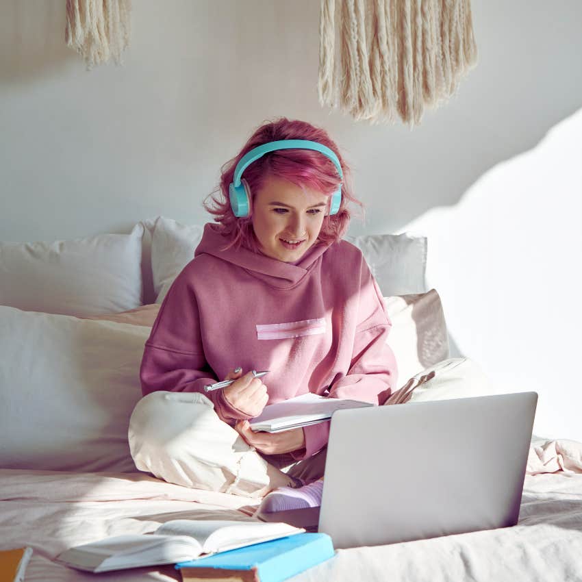Gen Z worker with pink hair and headphones