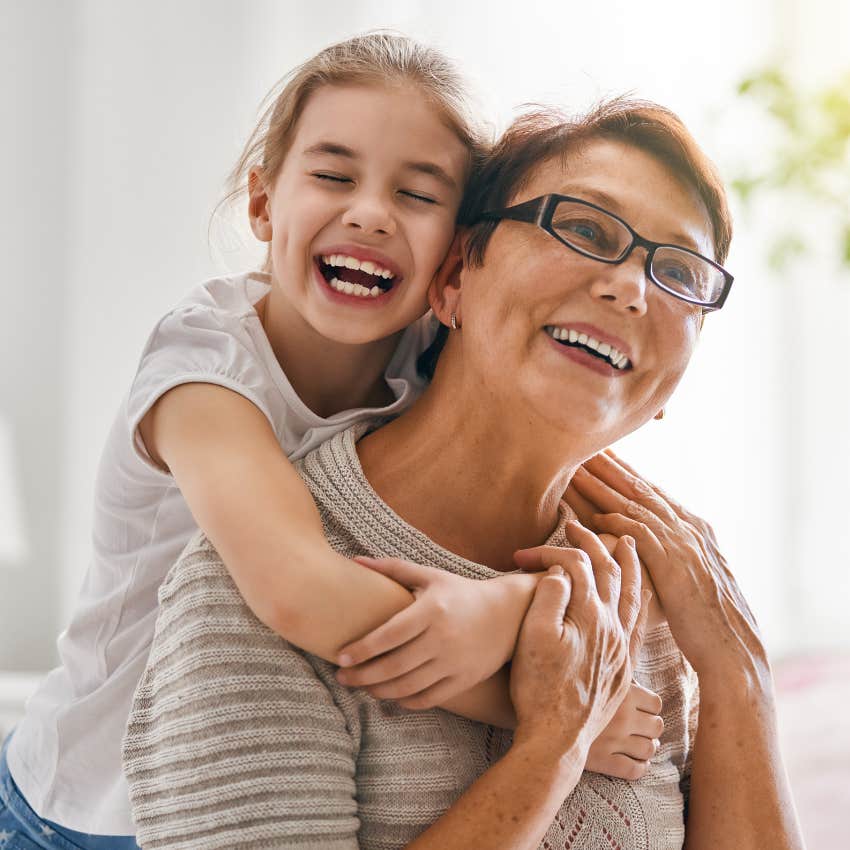 Grandmother hugging her young granddaughter. 