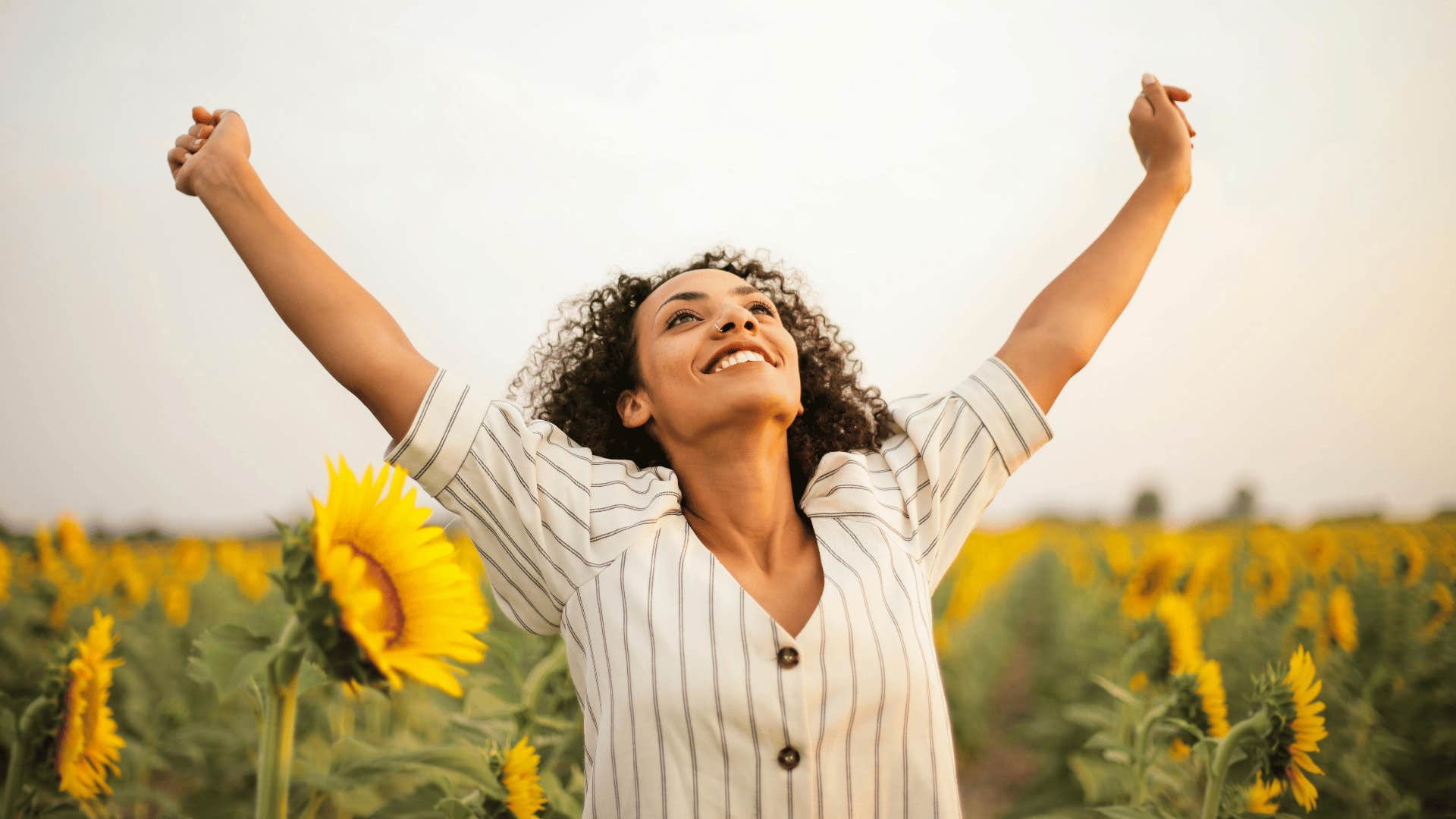 confident woman in sunflower field