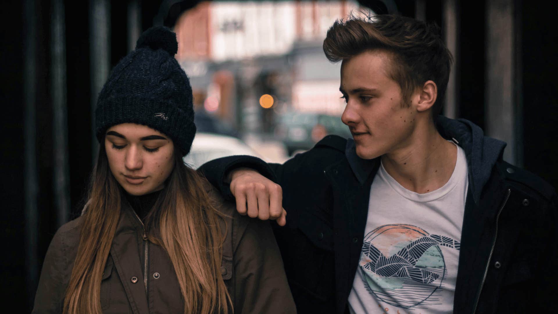 smart man walking alongside woman