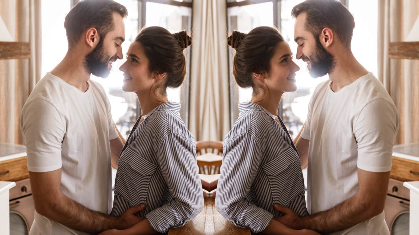 husband and wife smiling at each other in kitchen