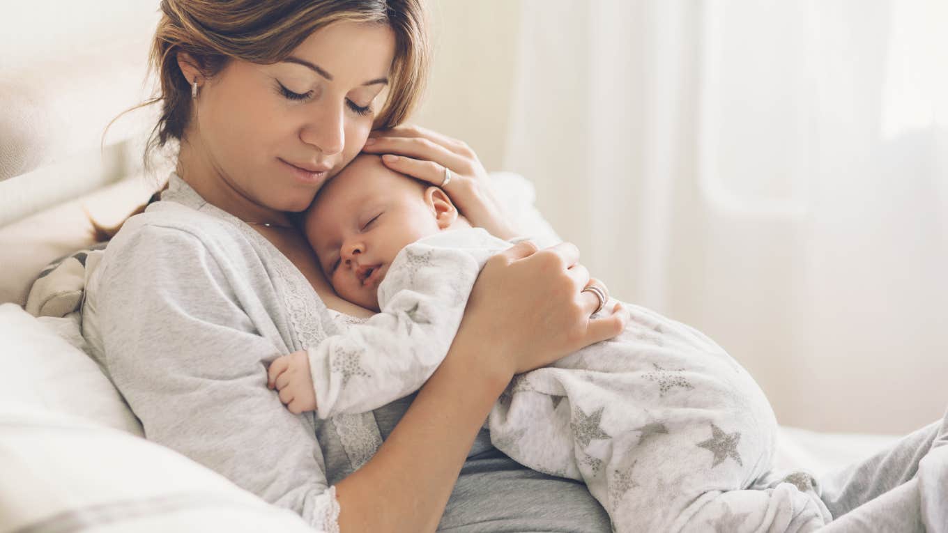 mom holding a sleeping baby