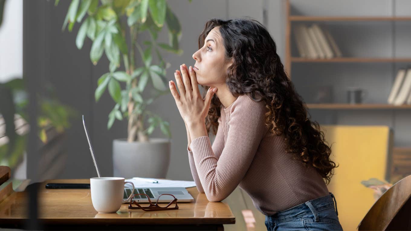 Worker looking frustrated and feeling resentful at her desk. 