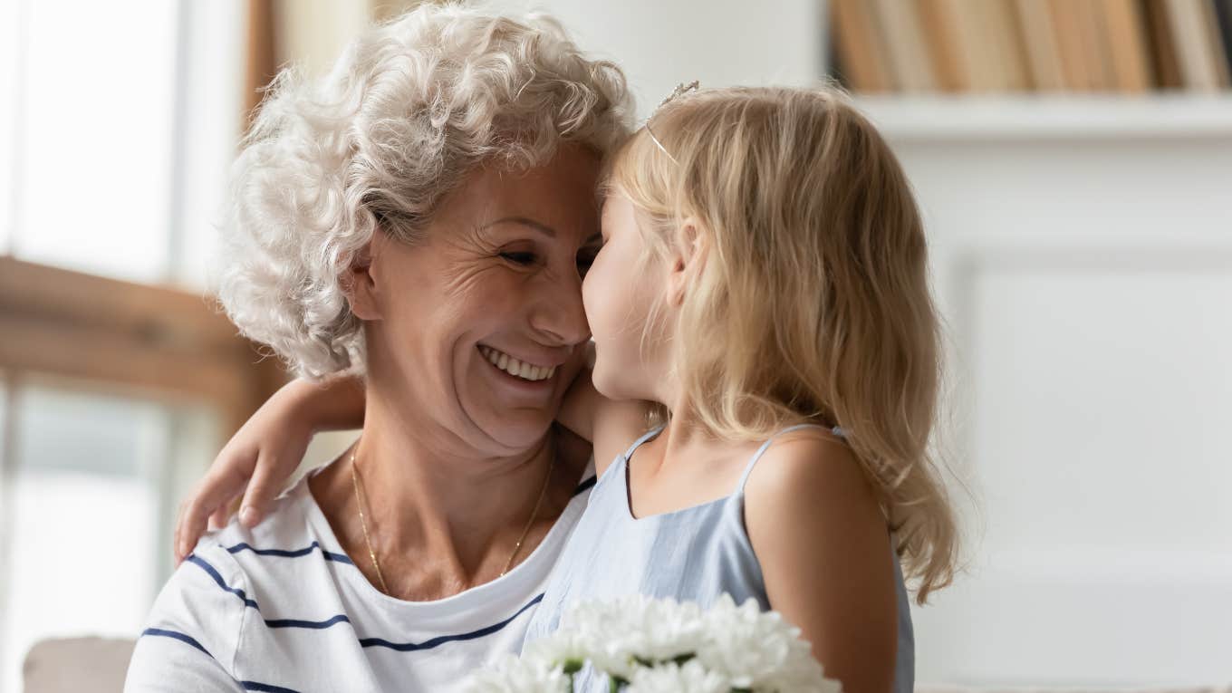 granddaughter hugging smiling grandmother