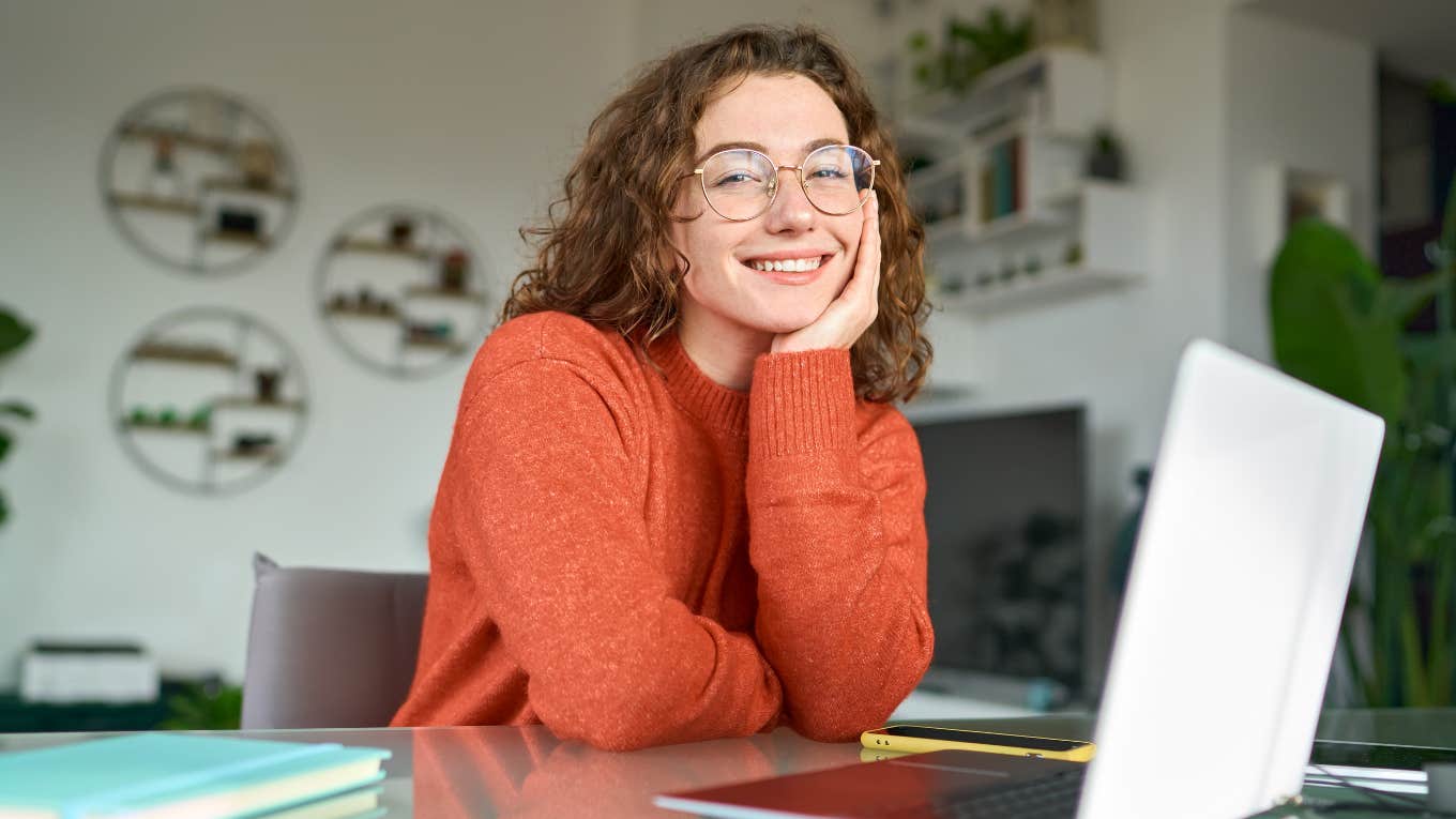 3 Crucial Things Workers Need To Be Happy With Their Jobs woman working on laptop and smiling