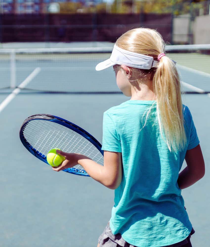 little girl playing tennis