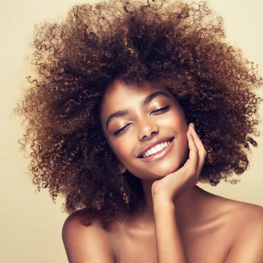 portrait of african american woman with clean healthy skin on beige background