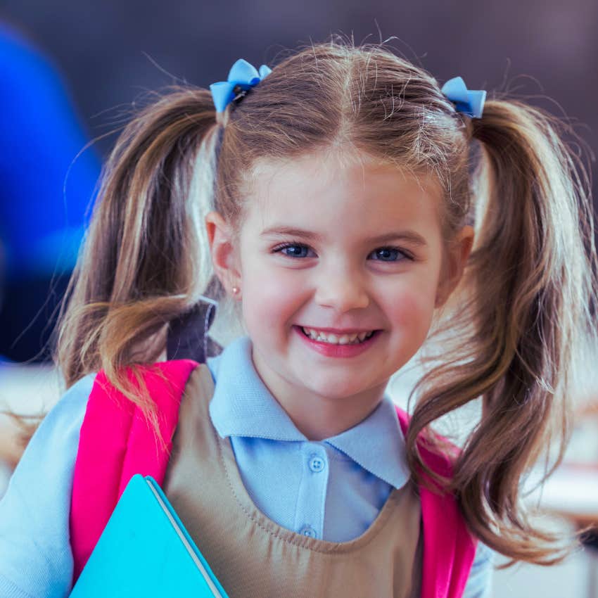 little girl with pigtails and a pink backpack