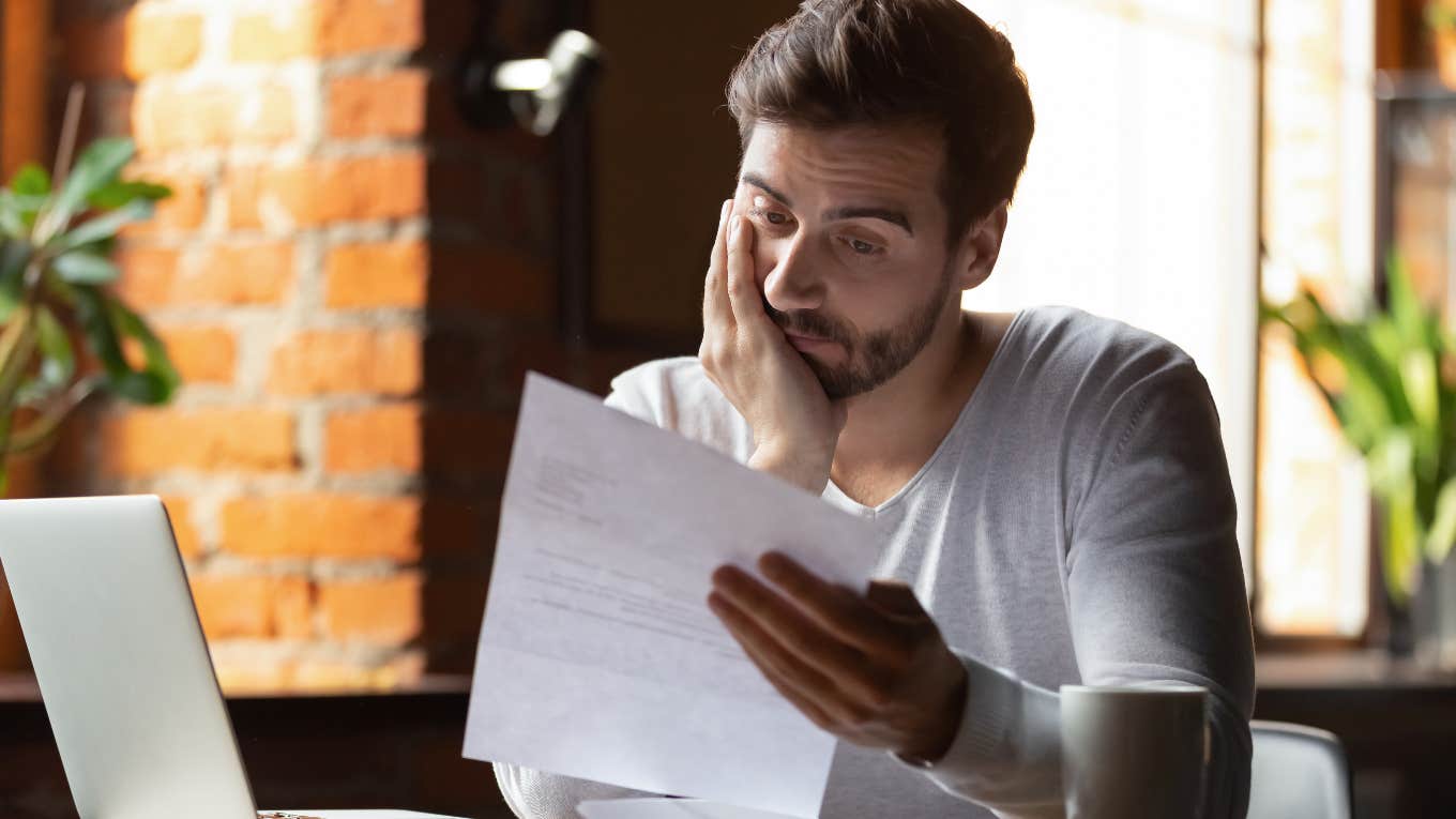 Concerned man reading $500 million dollar bill from Verizon