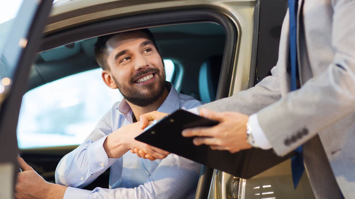 Man Finds Out He’s Banned After Trying To Rent A Car Man sitting in a rental car grabbing the keys.