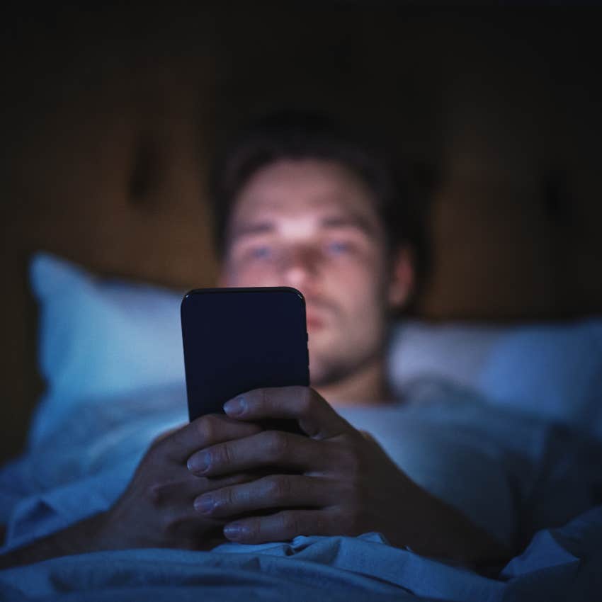 Man on phone in bed