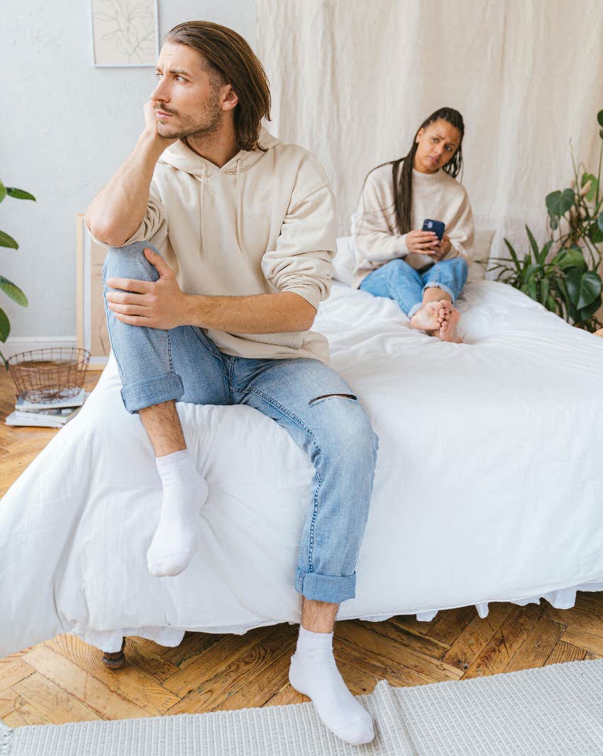 couple on bed woman looking longingly at man