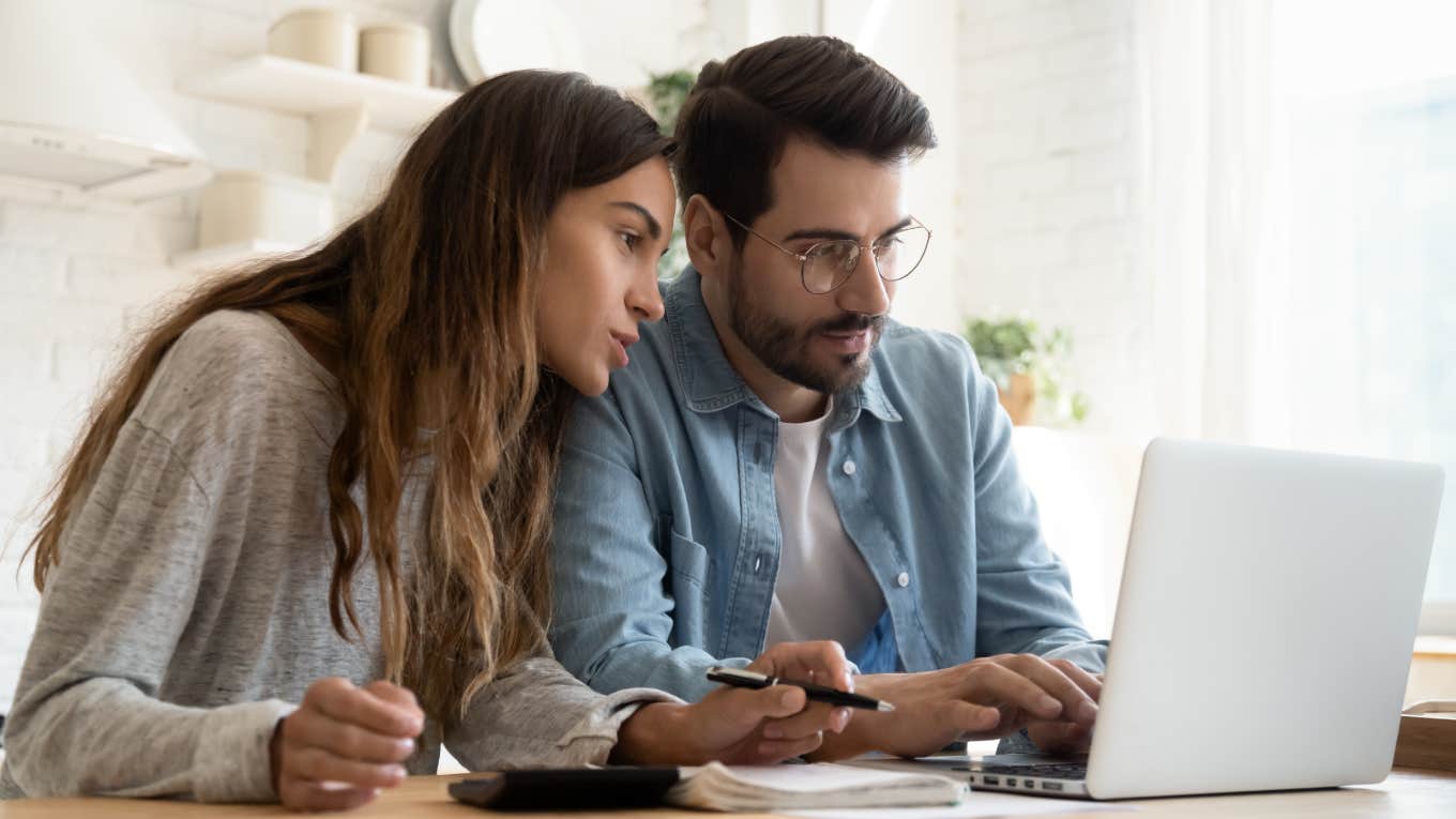 Married Couple Sitting In Their Poorness Discuss How It's Possible They Overspend young couple calculating bills and looking at laptop screen