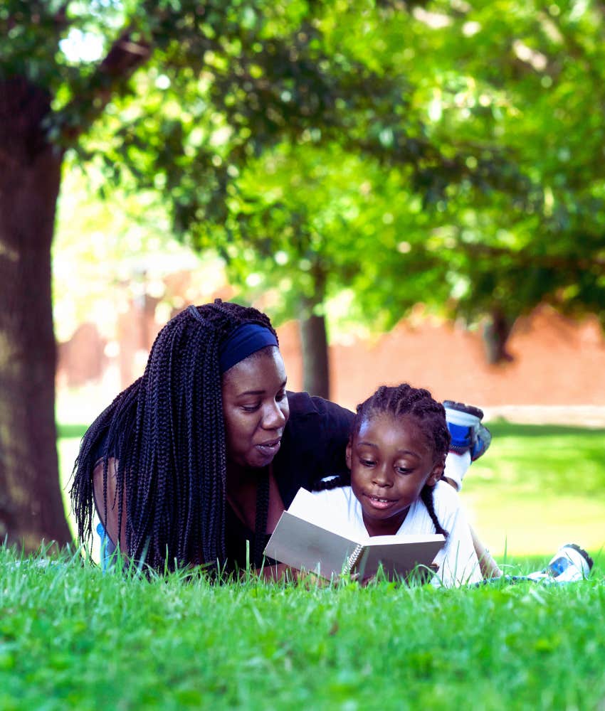 mom and son reading in the park