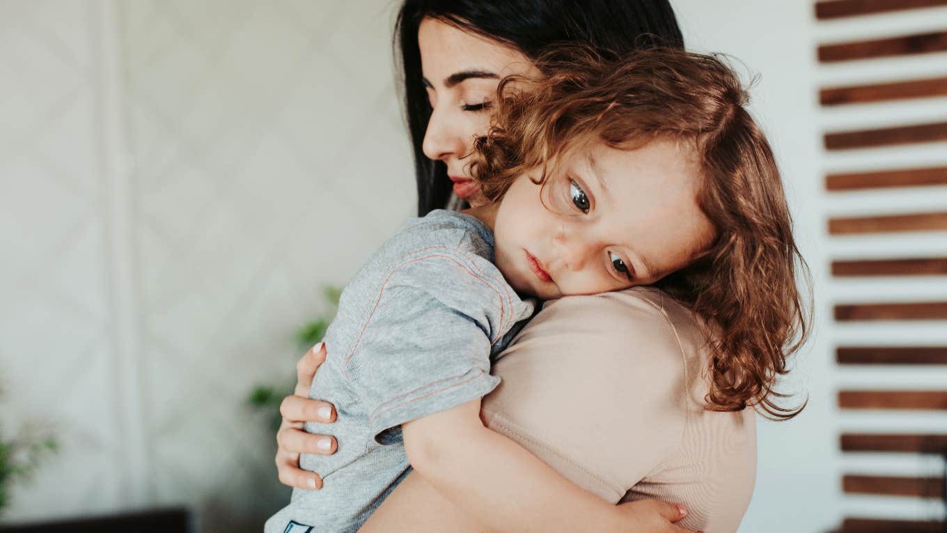 mom holding impressionable child