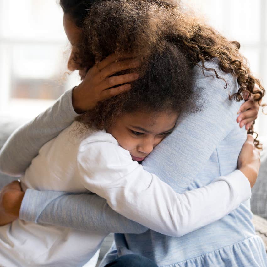 Mom hugging her anxious daughter