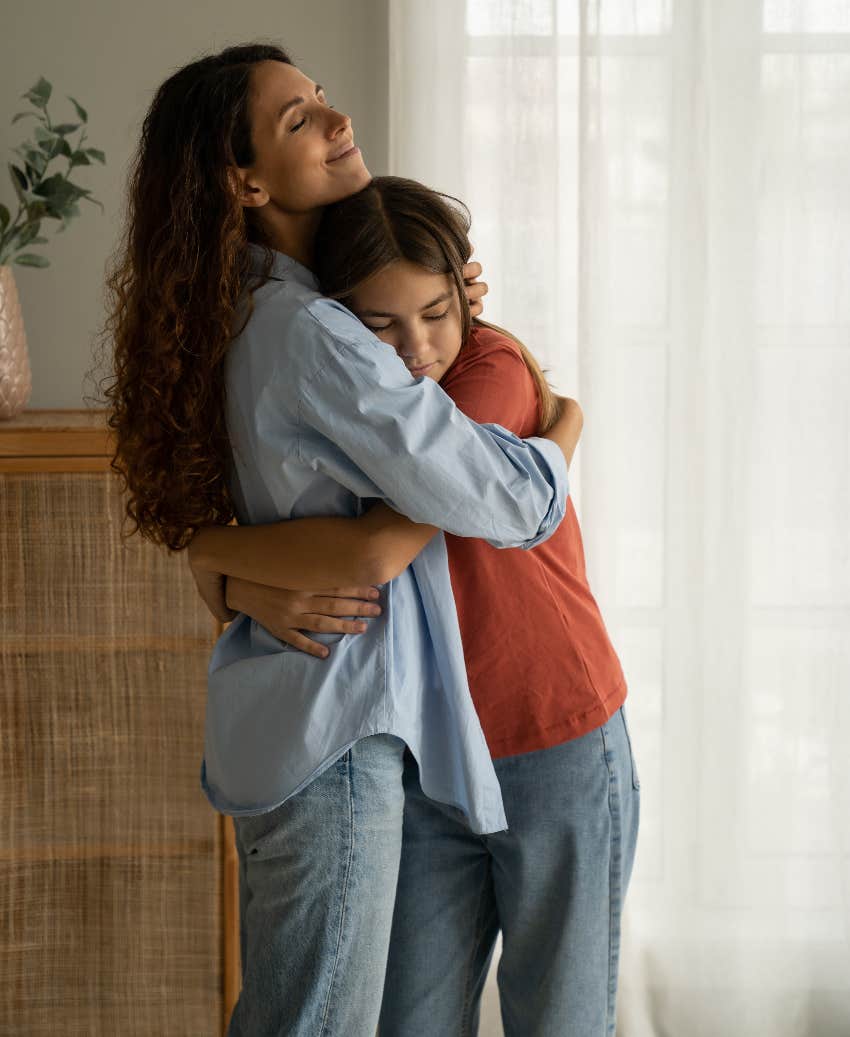 Mom hugging daughter