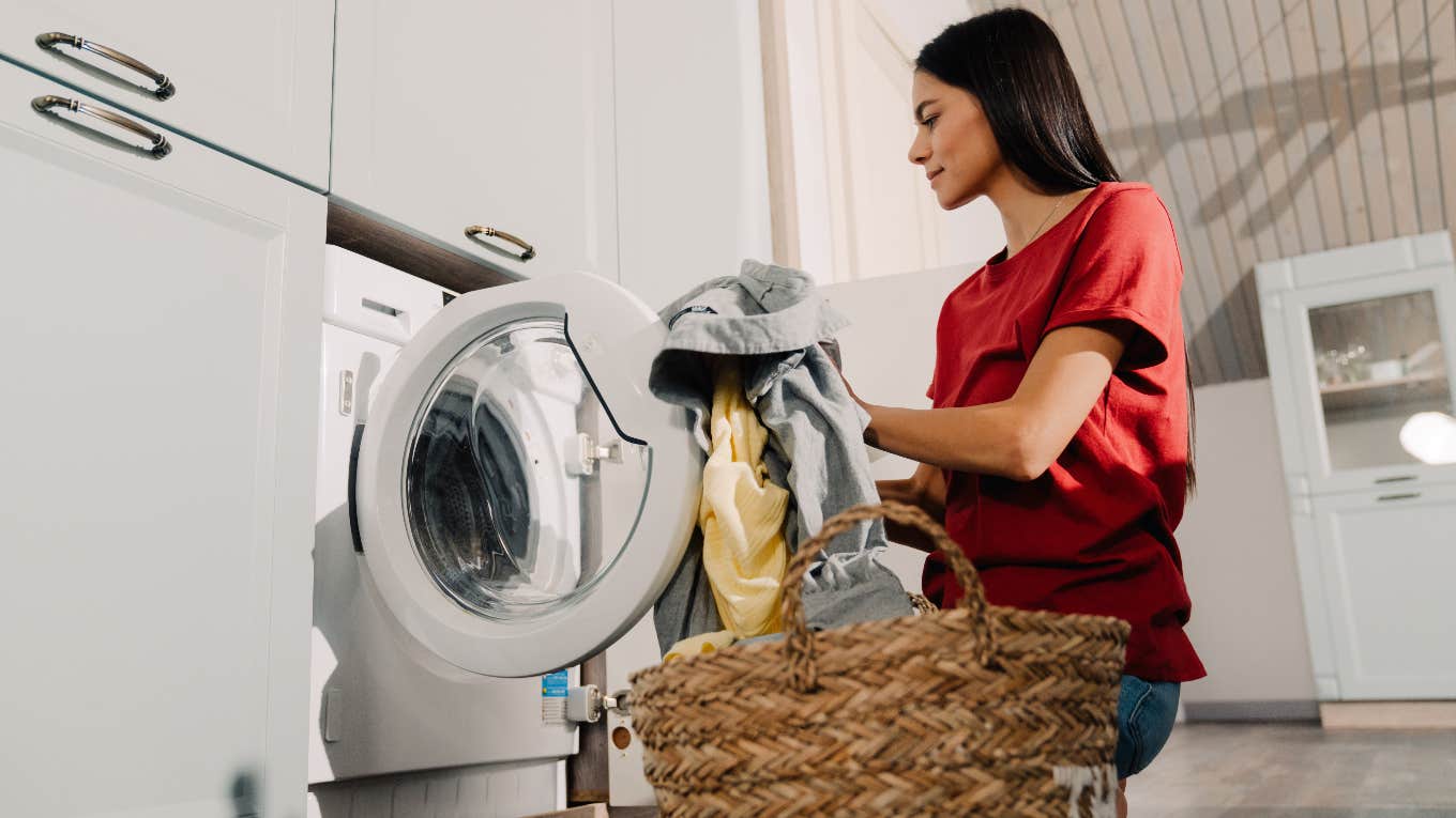 Mom's Strange Laundry Soap Obsession May Be A Post-Pregnancy Coping Mechanism woman loading laundry into washing machine