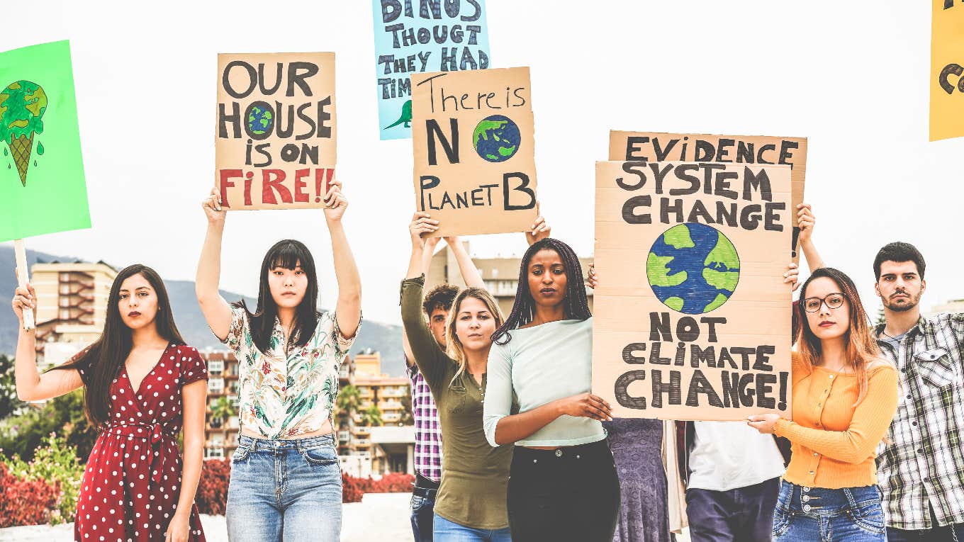 Nearly Half of Gen Zers & Millennials Are Quitting Their Jobs Because Of Climate Change Young climate activists holding signs