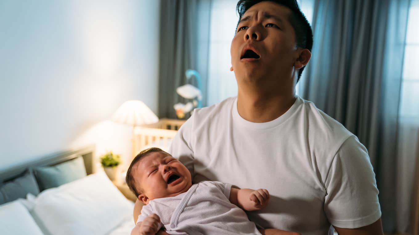 frustrated dad holding his baby