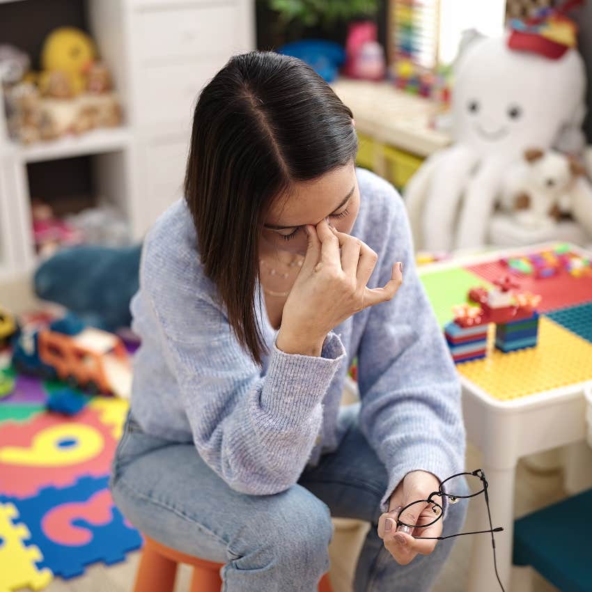 Overwhelmed teacher working late