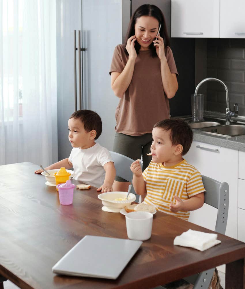 mom on phone with two kids