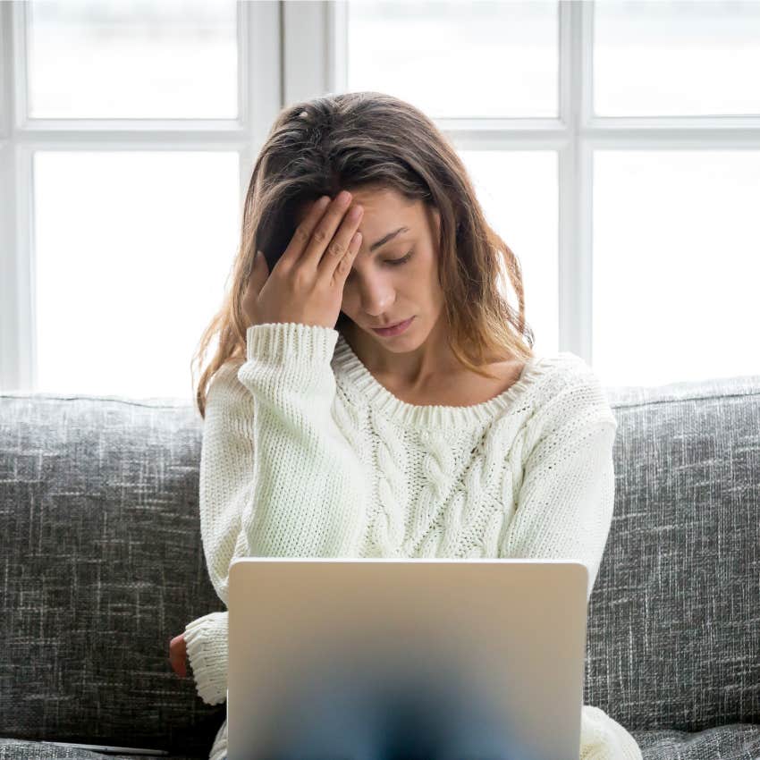 woman looking stressed working on laptop
