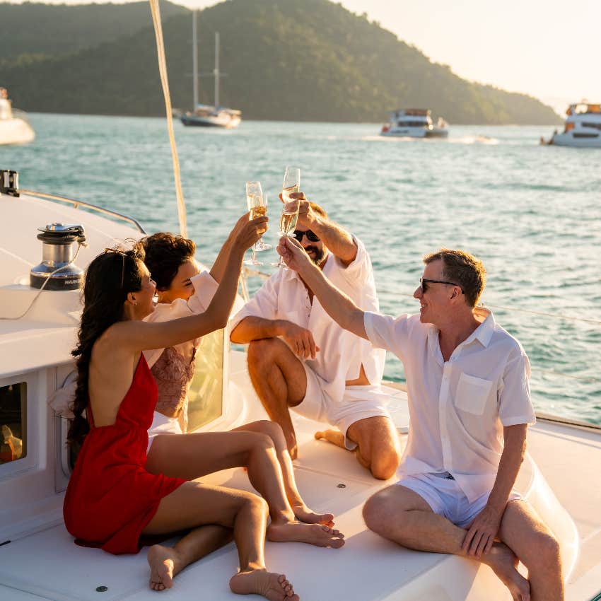 Rich friends spending money on a boat with champagne 
