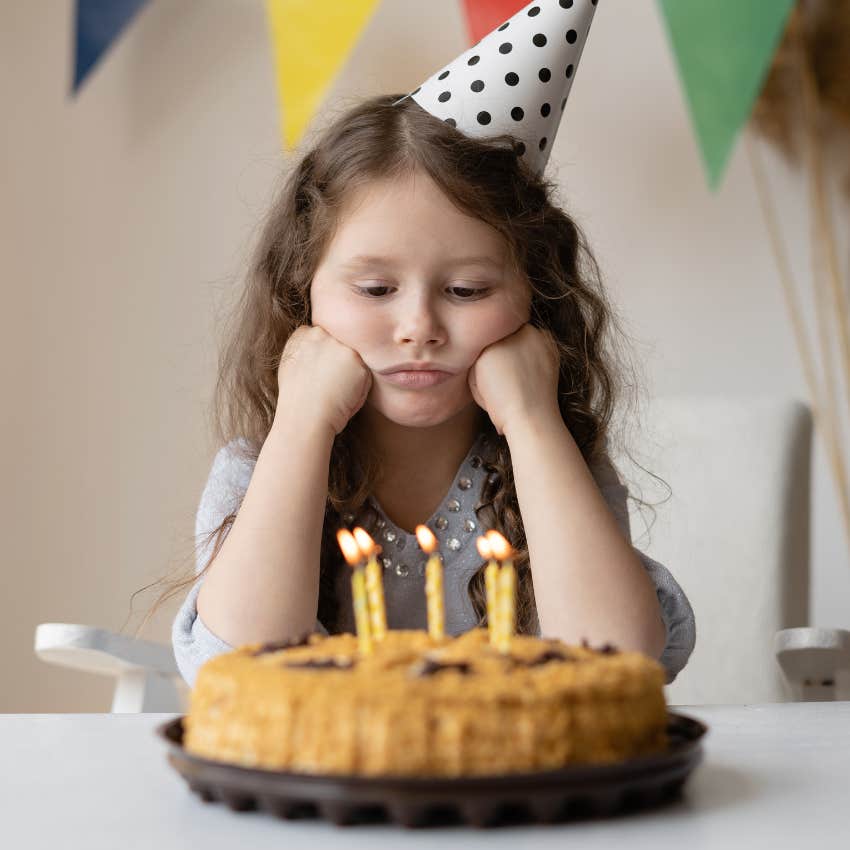 Sad little girl at her birthday party. 
