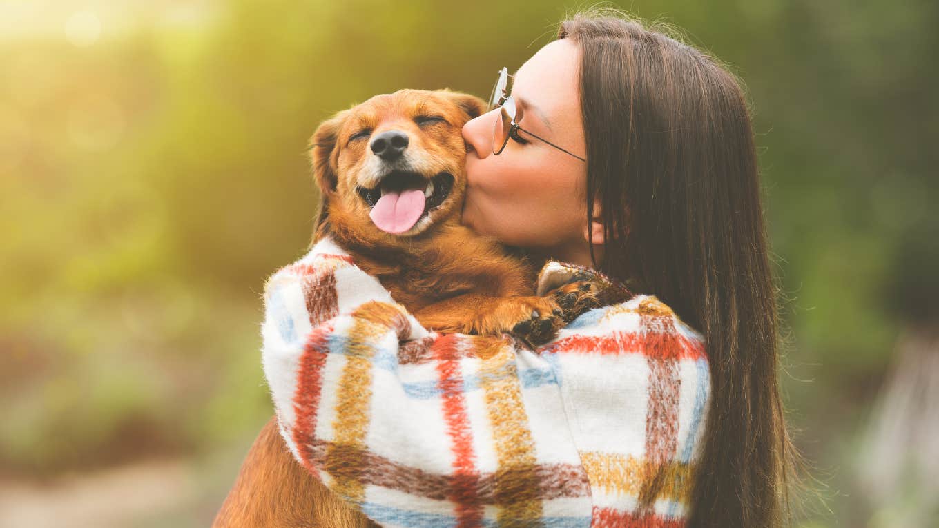woman hugging a dog 
