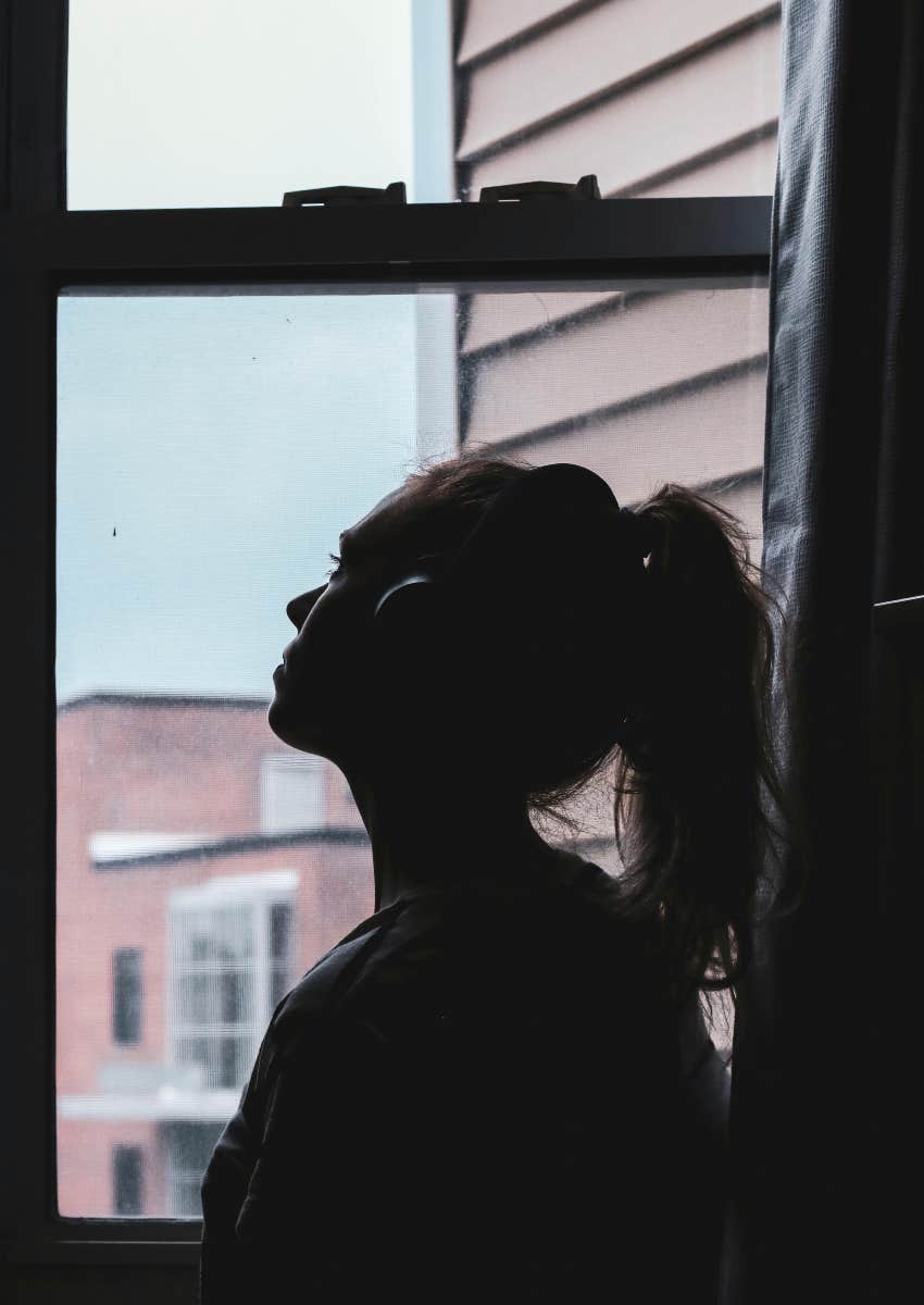 sad woman looking out window