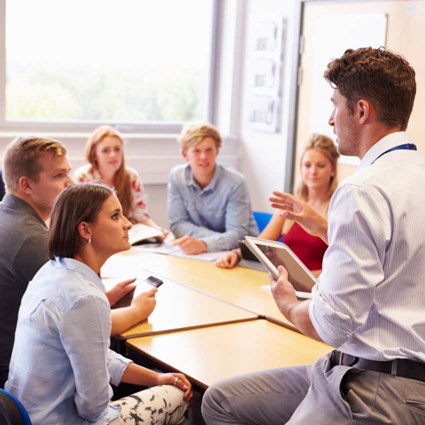 Teacher With College Students Giving Lesson In Classroom