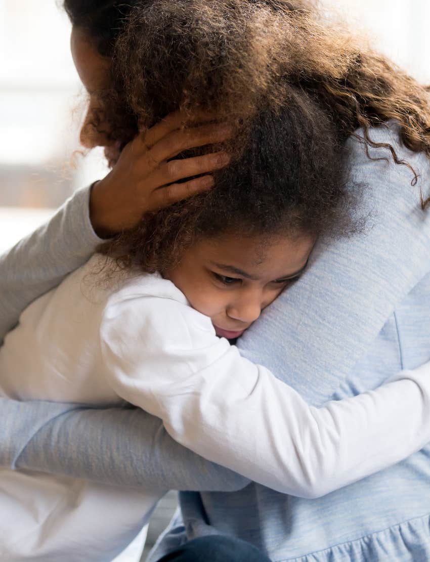 Mother raising kind kid by hugging her