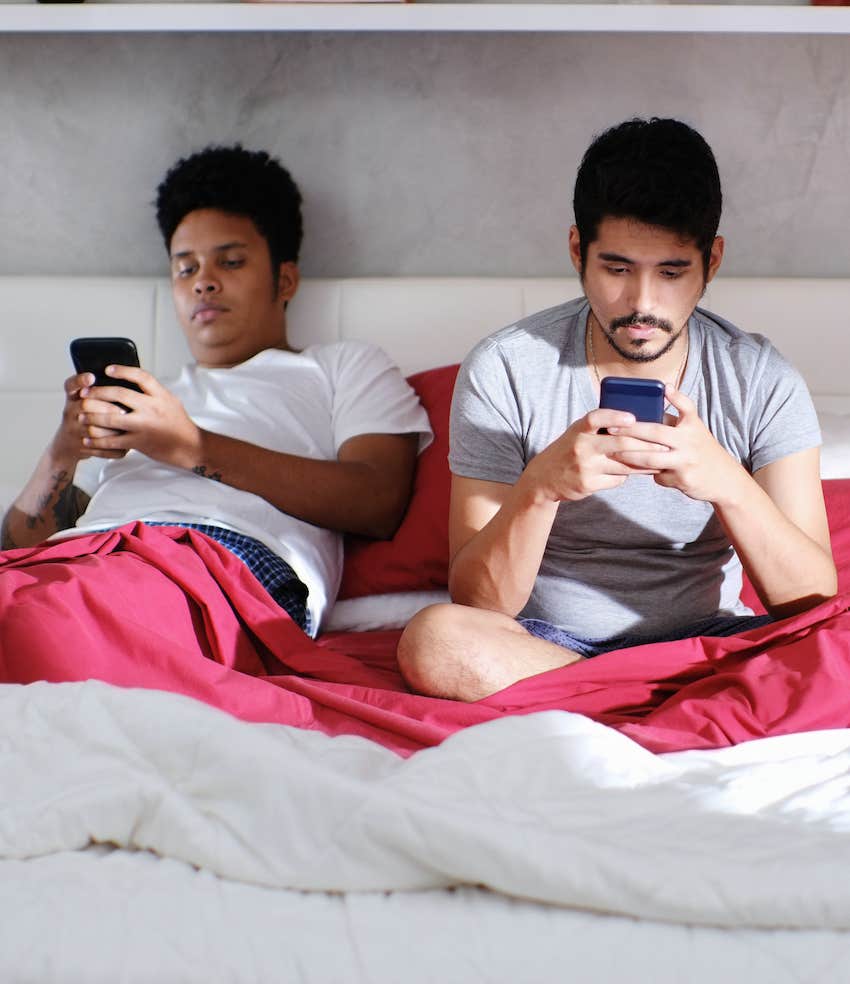 Couple in bedroom ignore each other