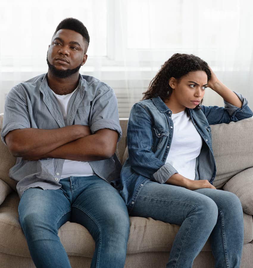 Couple on couch having a fight that might destroy their relationship