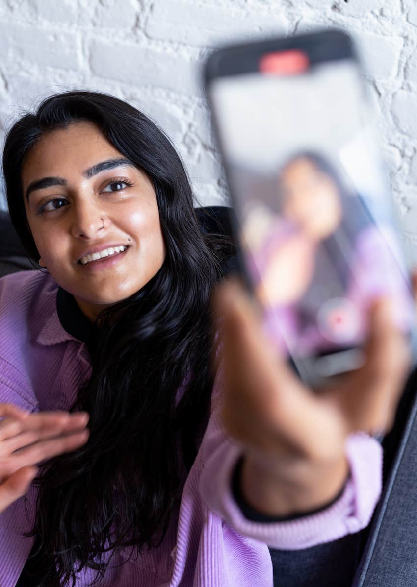 She takes a selfie for her online dating profile