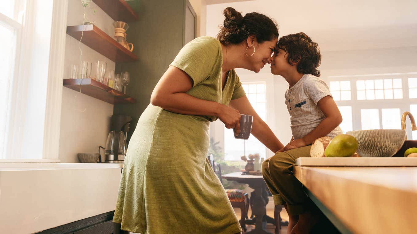 Single Mom Doesn't Believe In Child Support Because She Made The Decision To Have A Baby Affectionate mother touching noses with her young son in the kitchen