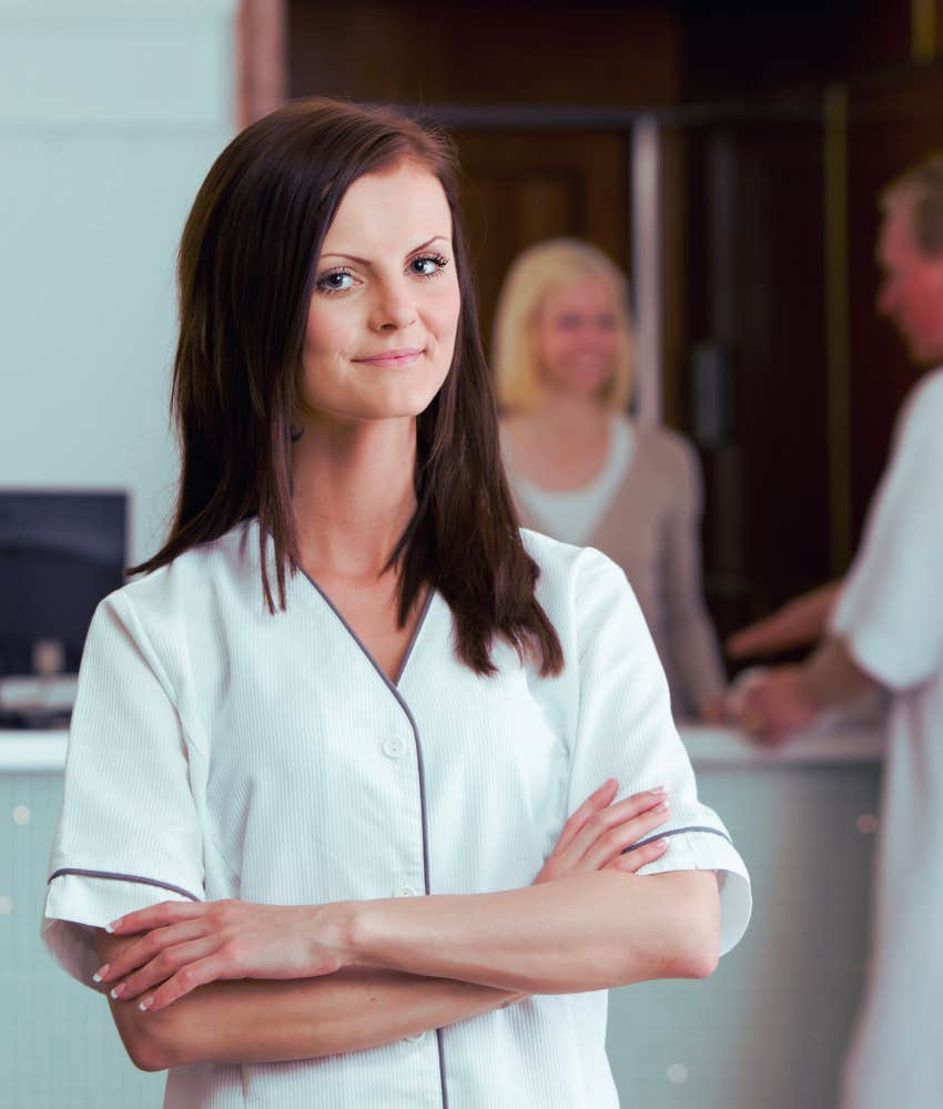 spa employee standing with arms crossed