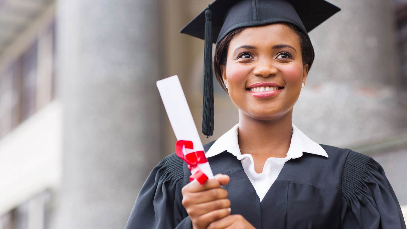 Student Feels Insecure About Graduating From A Community College female graduate in cap and gown holding a diploma