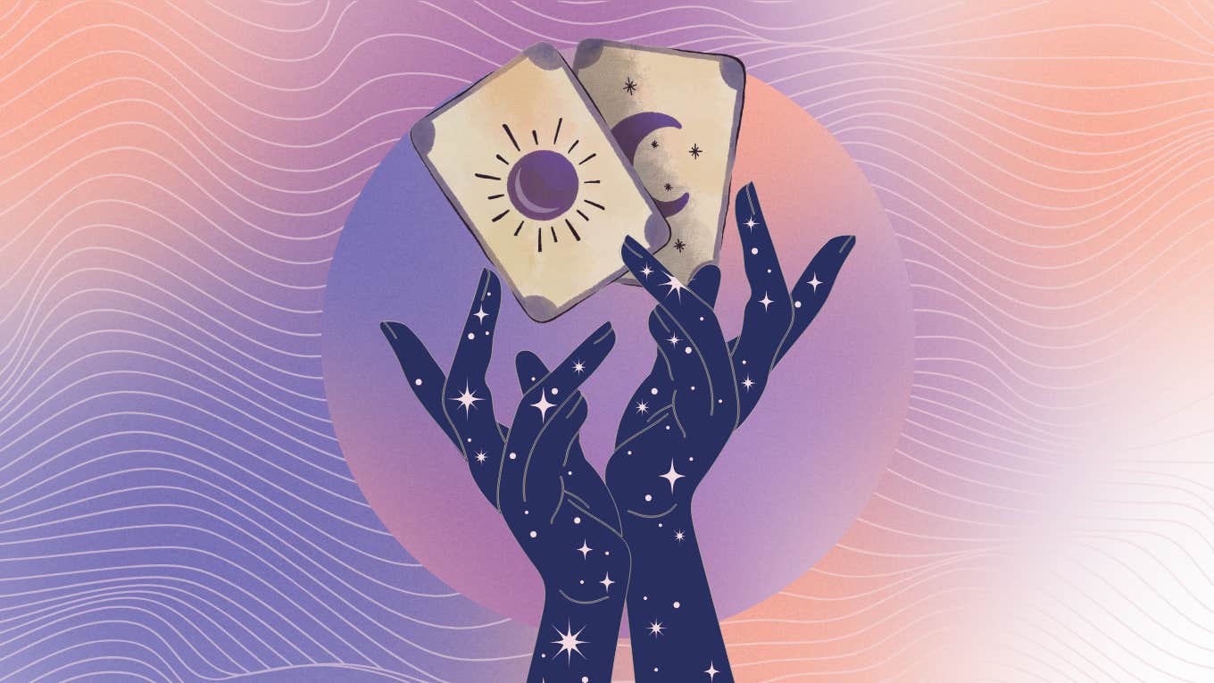 hands holding tarot cards for may 26 reading