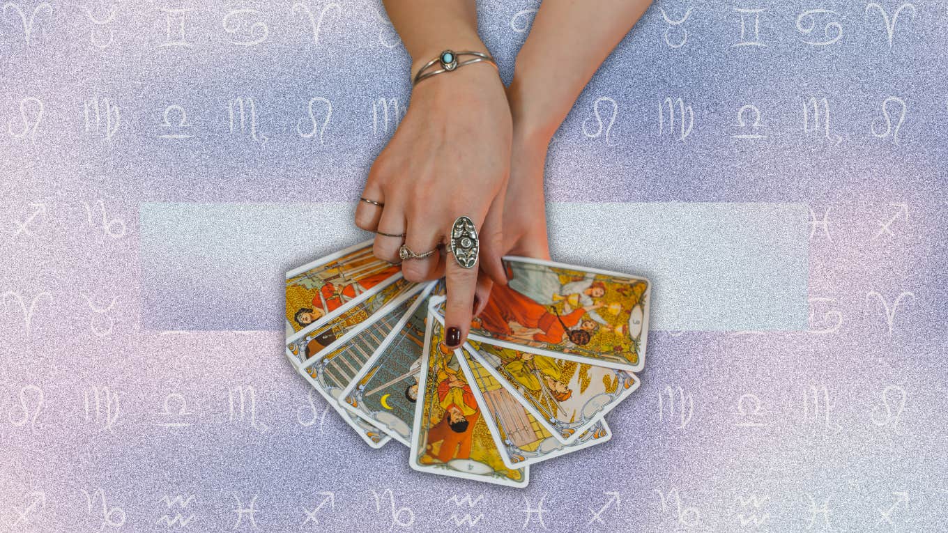 Each Zodiac Sign's Tarot Card Reading For May 31, 2024 hand holding tarot card for horoscope may 31
