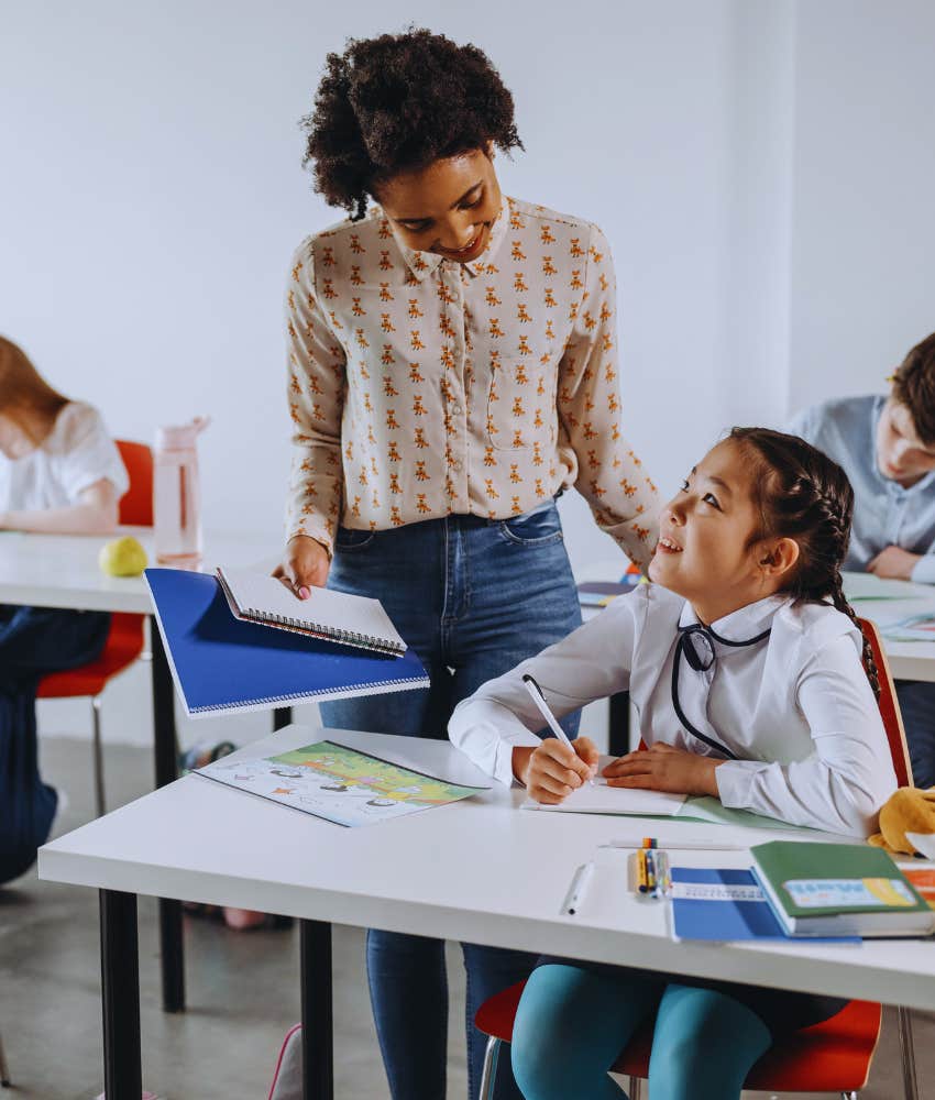 teacher helping student in class