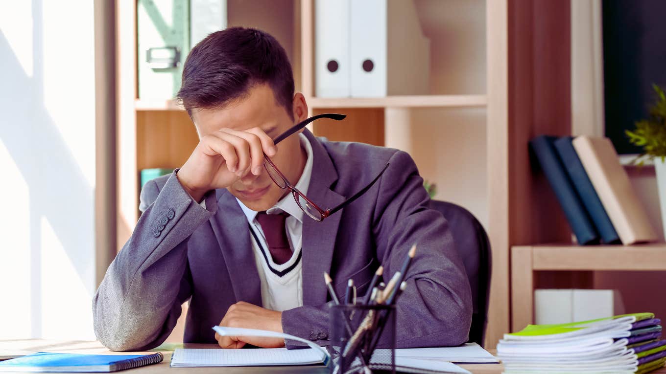 frustrated teacher sitting at desk