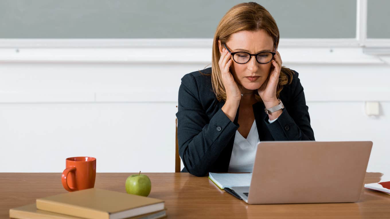 Teacher Worries After Student With ‘Severe Behavior Issues’ Learns Where She Lives Teacher looking nervous while sitting at her desk.
