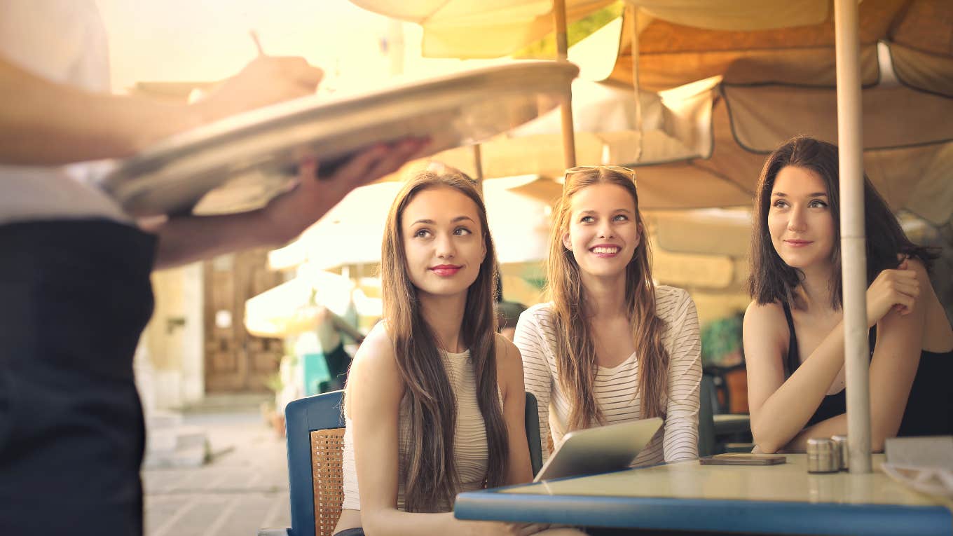 group of teen girls ordering at a restaurant