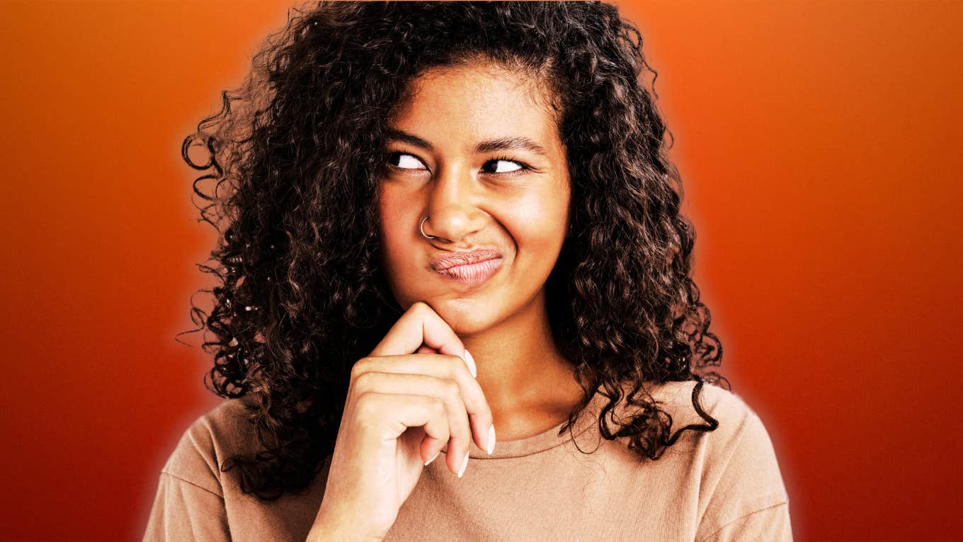 Secretly jealous woman looking suspiciously over her shoulder